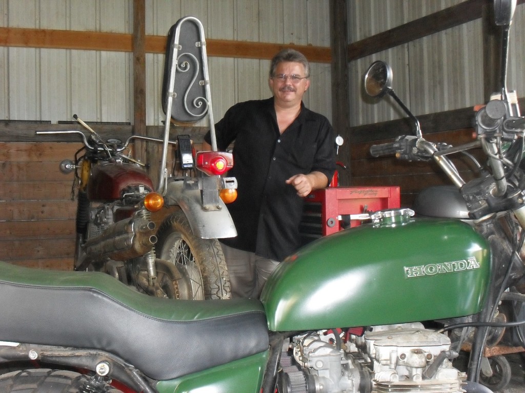 Floyd poses with his recently completed 1980 Honda CB650C converted to a scrambler (foreground) and a barn fresh 1970 Honda CL450 factory built scrambler that needs a total restoration.